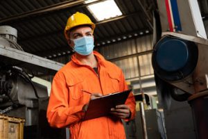 Man with ppe and clipboard